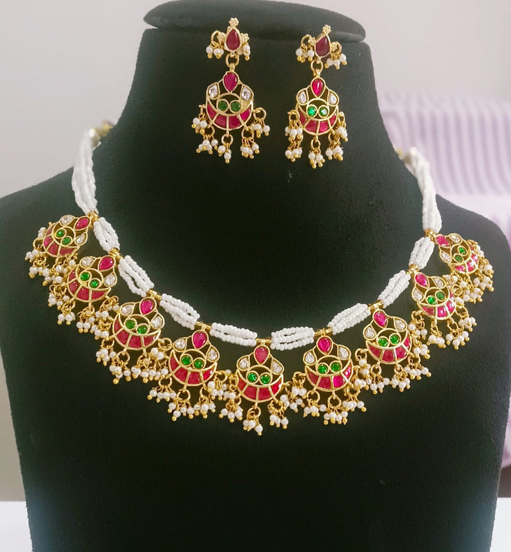Pendant necklace featuring a charm chain